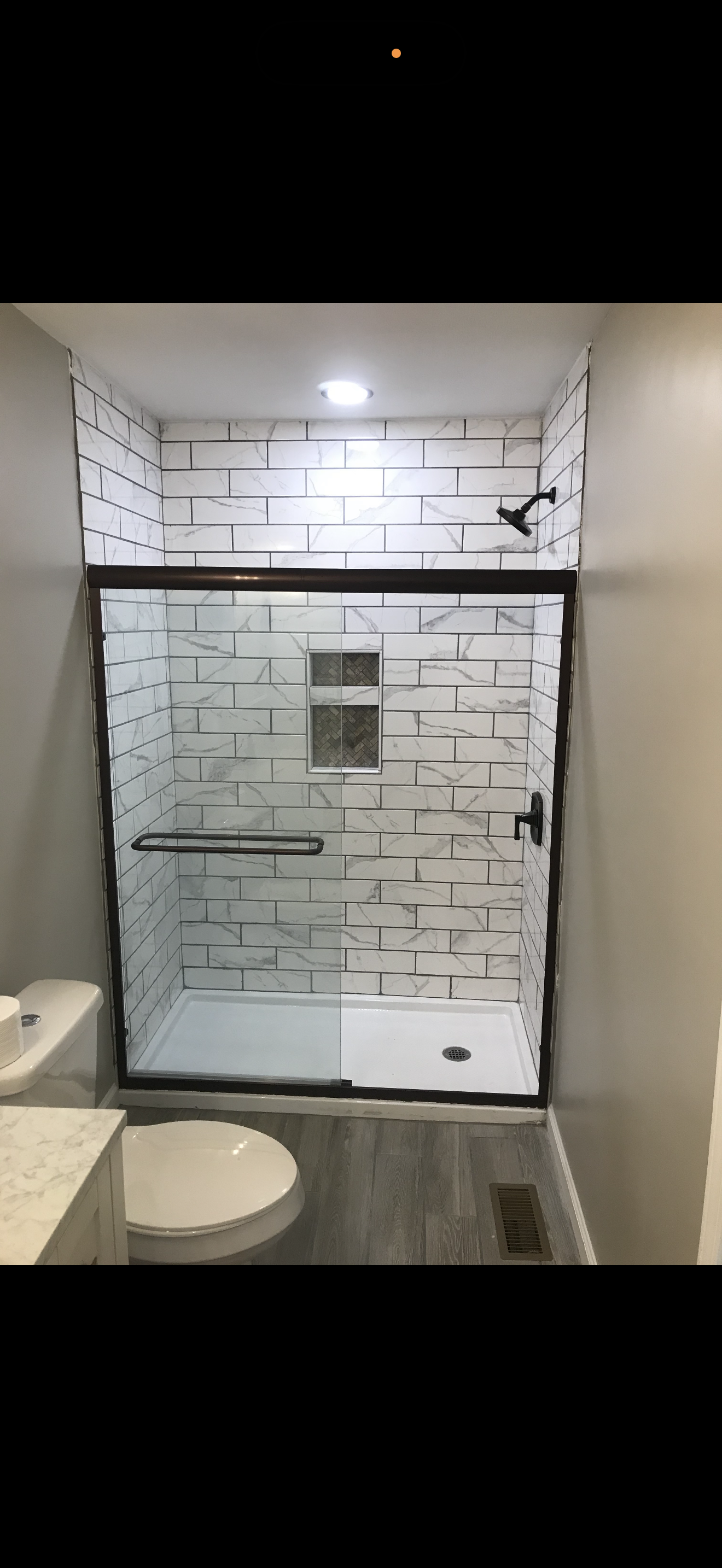 Bathroom remodel: updated shower/tub area with modern finishes and refreshed fixtures.